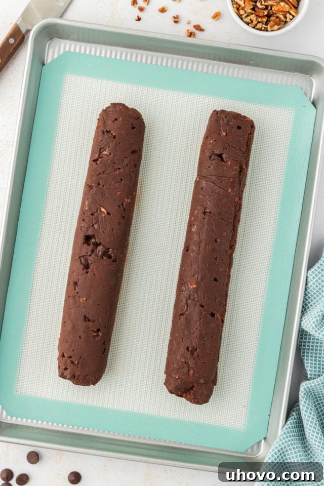 An overhead view displaying neat slices of chilled double chocolate cookie dough arranged on a baking sheet, ready for the oven.
