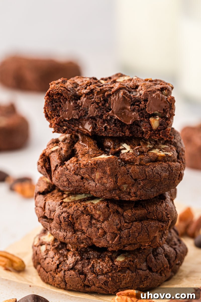 A tempting stack of four perfectly baked double chocolate cookies, showcasing their inviting texture and rich color.