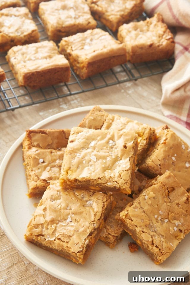 Salted Butterscotch Blondies piled artfully on a beige plate