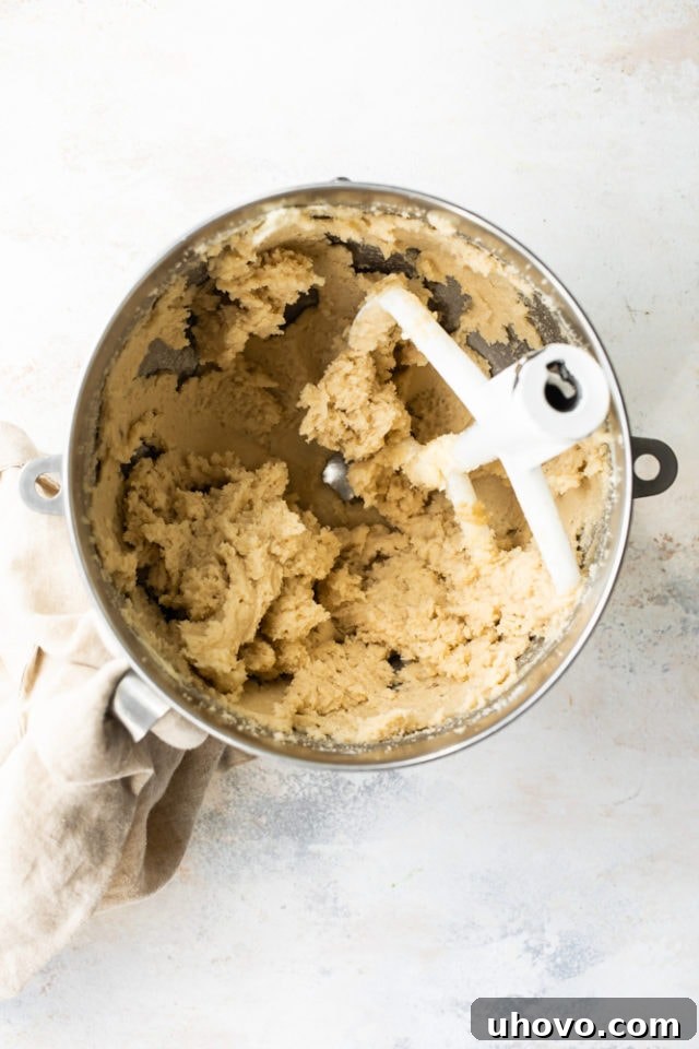 Overhead view of beautifully creamed butter and brown sugar in a mixing bowl, showing light and fluffy texture