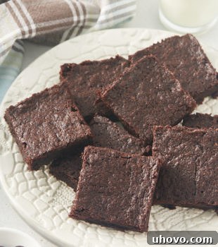 pile of brownies on a white plate