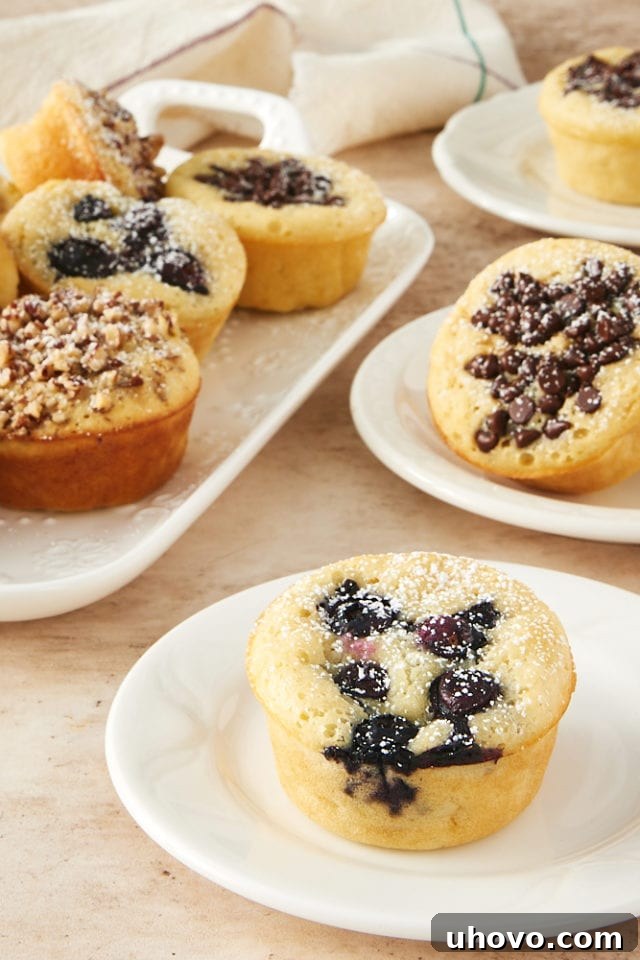 Freshly baked Pancake Muffins served on pristine white plates, ready for breakfast or a snack. Customizable with your favorite toppings for a personalized touch.