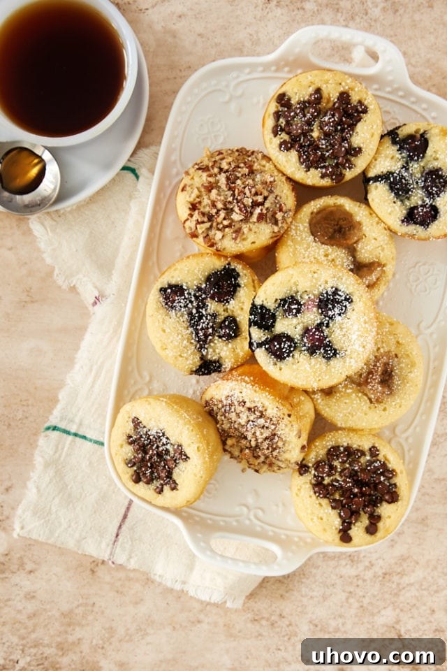 An inviting overhead view of freshly baked Pancake Muffins arranged on a rustic white tray, showcasing their fluffy texture and golden-brown tops, ready to be enjoyed.