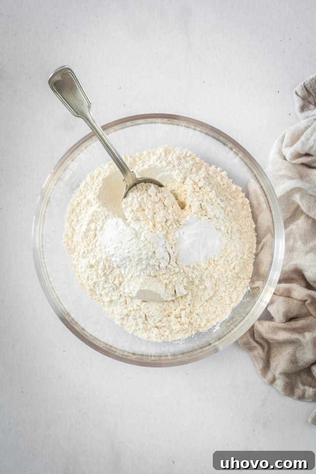 Overhead shot of dry cake ingredients in glass bowl