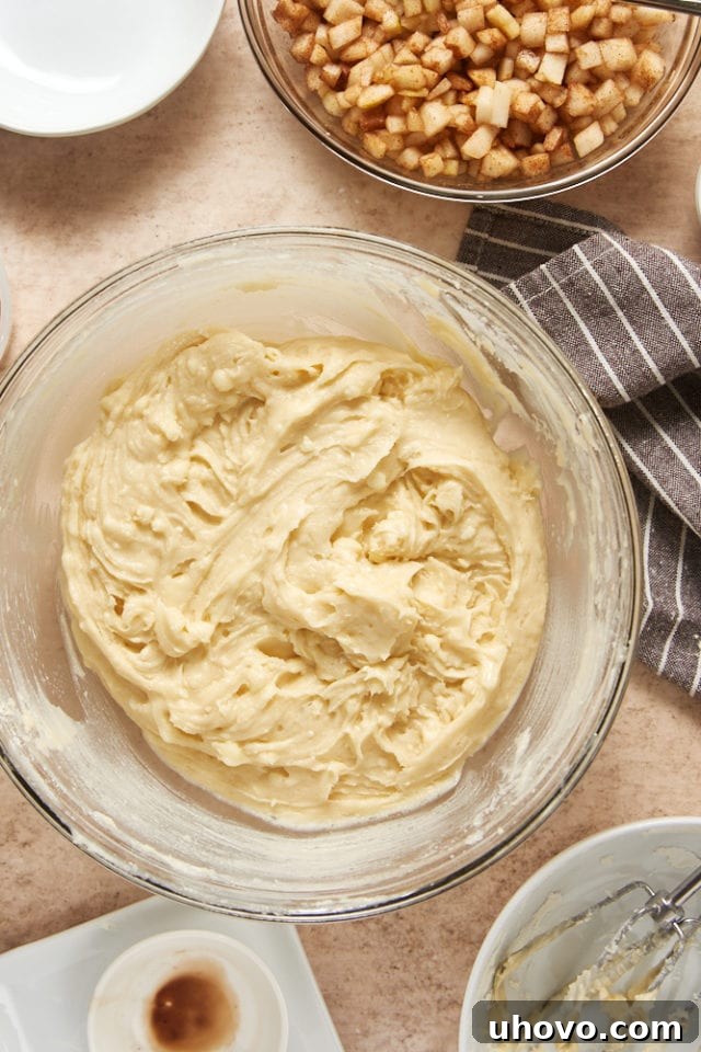 Smooth, well-combined Cinnamon Pear Cake batter in a glass mixing bowl, before the pears are added.