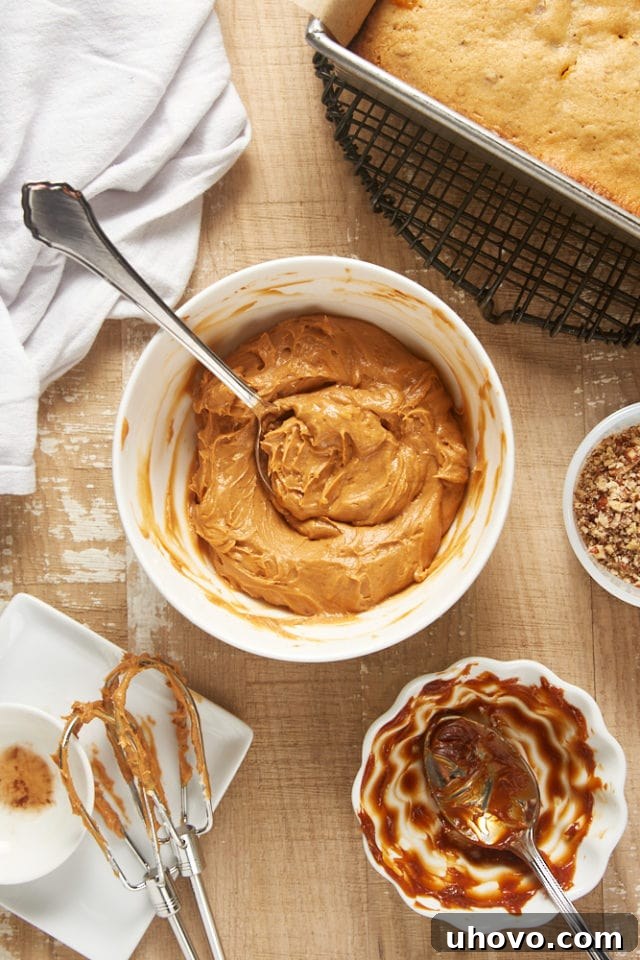 Overhead view of smooth, creamy dulce de leche frosting in a white mixing bowl, ready to be spread.