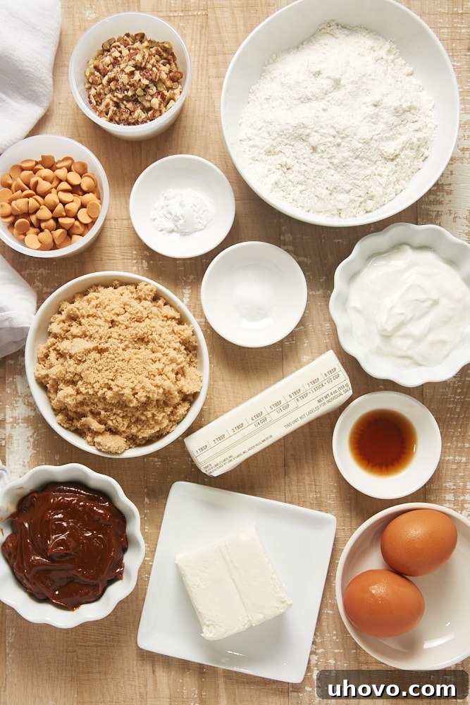Overhead view of various ingredients laid out on a baking surface for Brown Sugar Snack Cake with Dulce de Leche Frosting.
