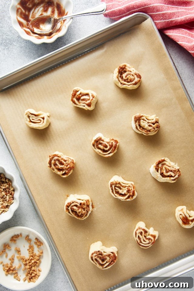 overhead view of Apple Butter Pinwheels on a parchment-lined baking sheet ready for the oven