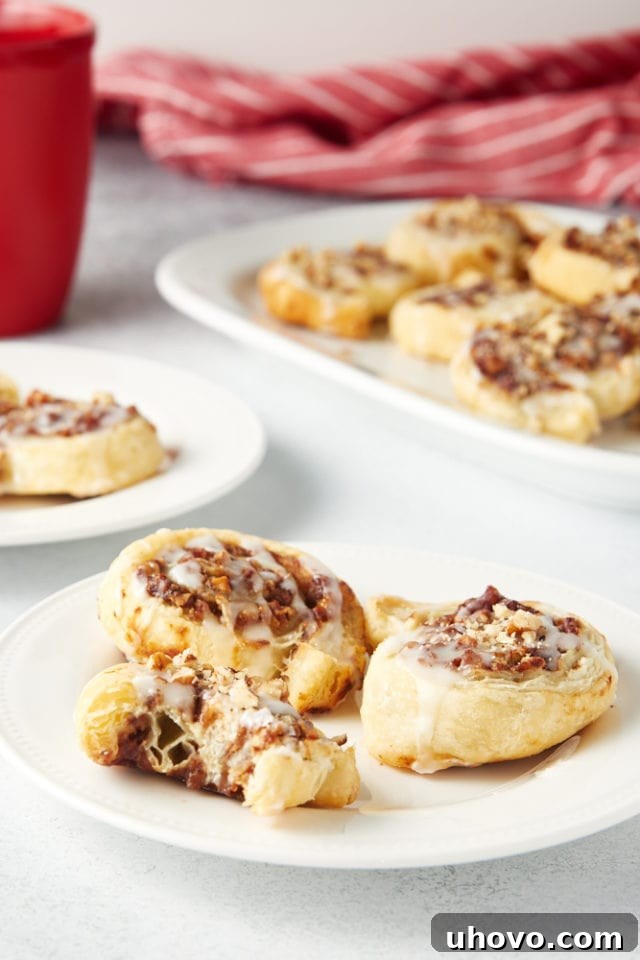 Apple Butter Pinwheels served on white plates and a white serving tray