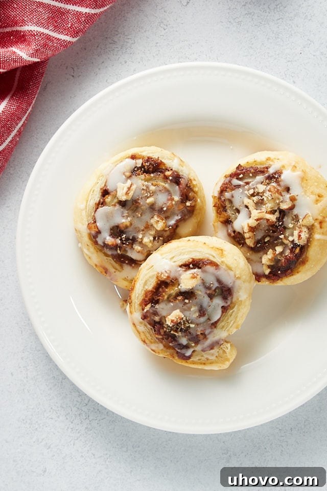 overhead view of three Apple Butter Pinwheels on a white plate