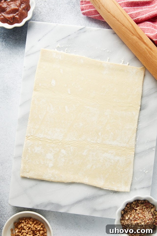 overhead view of puff pastry on a marble surface