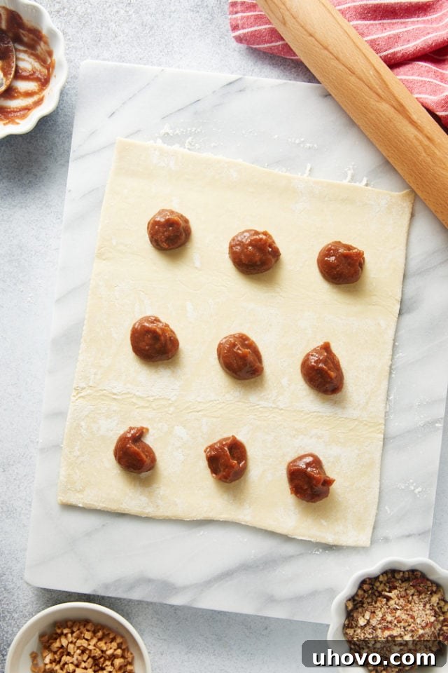 overhead view of apple butter dolloped on puff pastry
