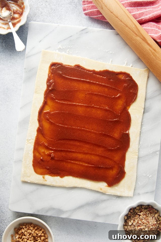 overhead view of apple butter spread on puff pastry