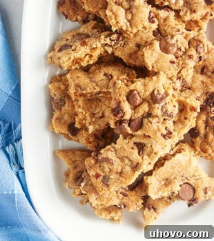 Overhead view of Triple Chocolate Chip Cookie Brittle glistening on a white tray