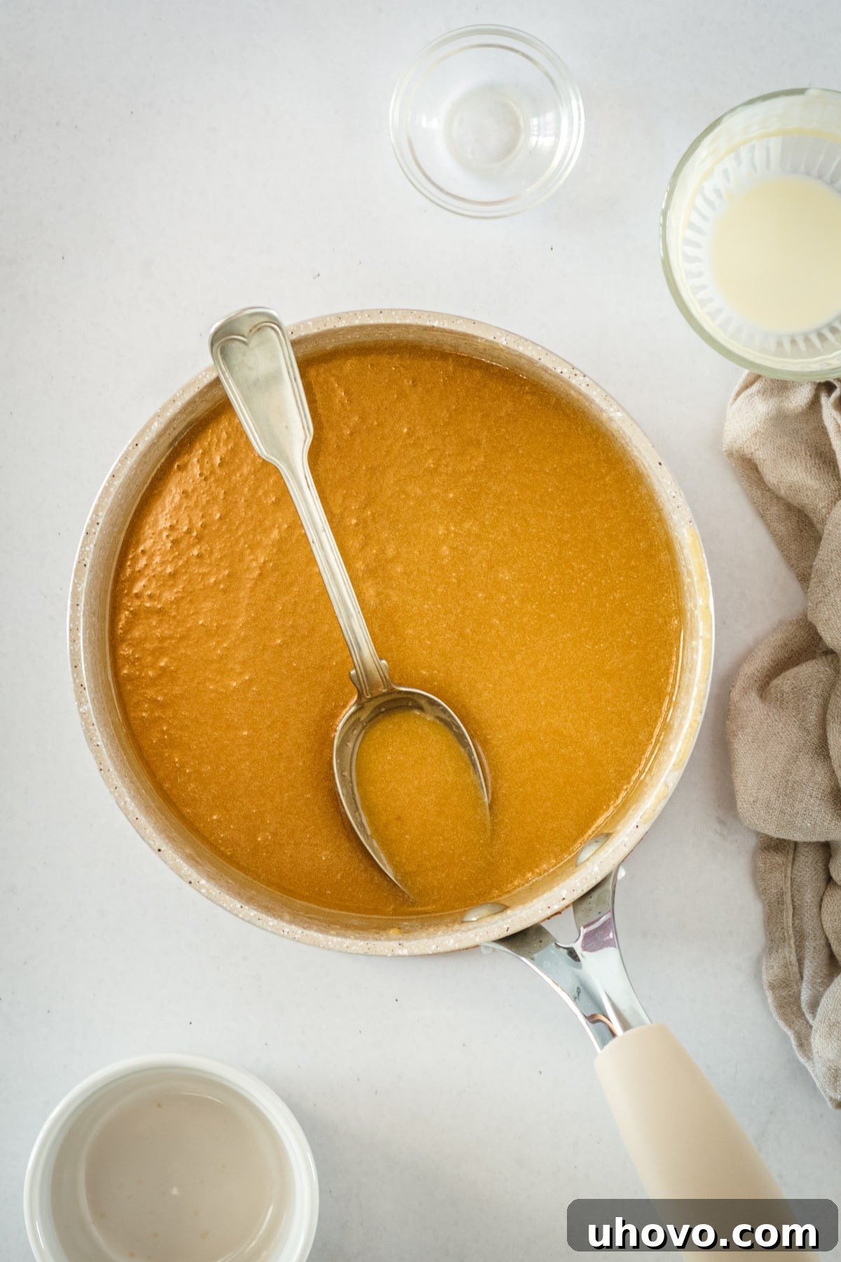 Overhead view of butterscotch in saucepan with spoon