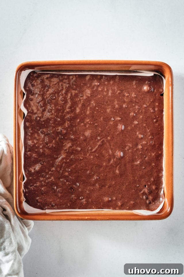 Overhead view of brownie batter in square pan