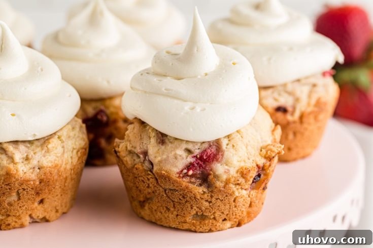 Strawberry cupcakes on a elegant cake stand, beautifully frosted and garnished