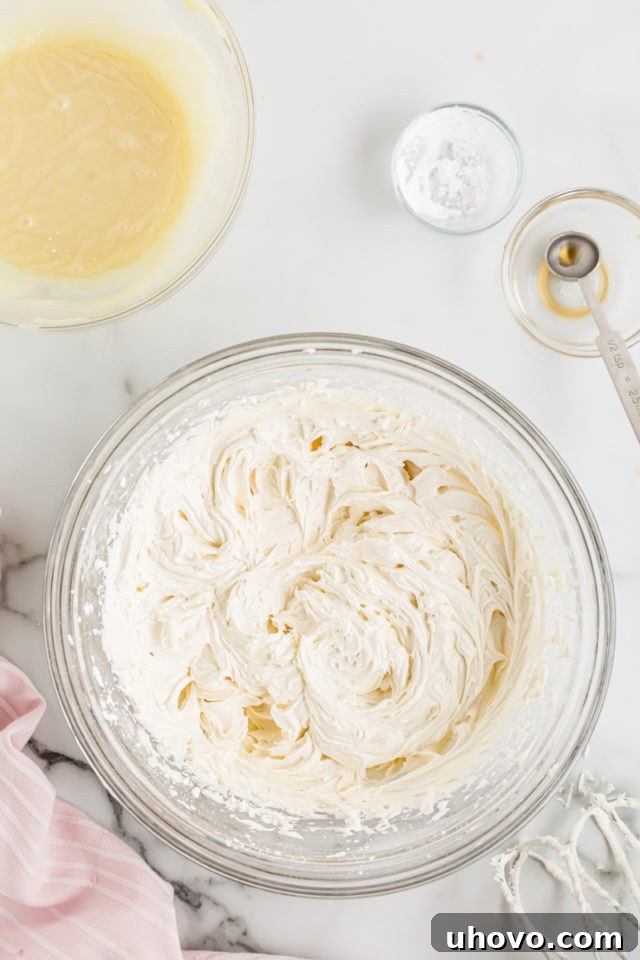 White chocolate frosting ingredients in a mixing bowl being beaten