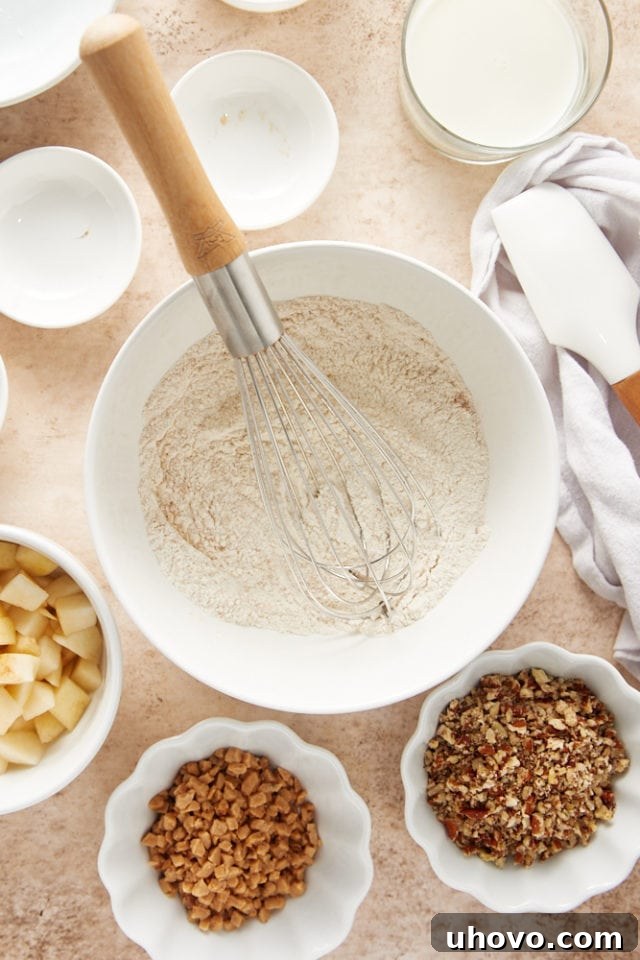 overhead view of dry ingredients for pear pudding cake in a white mixing bowl