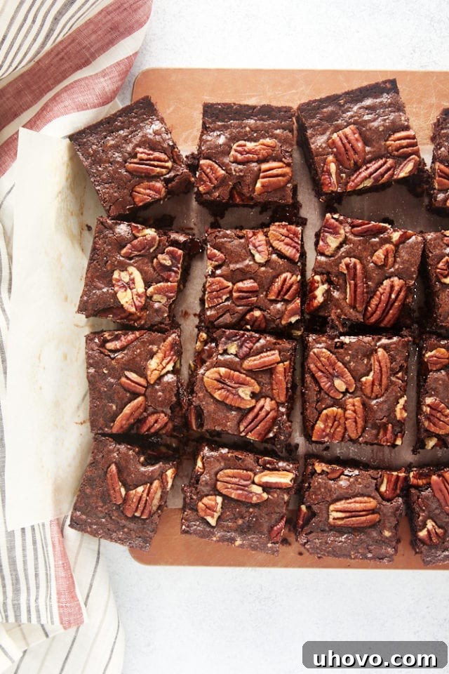 An overhead shot of freshly baked Pecan Lovers' Brownies meticulously cut into neat squares, ready to be served.