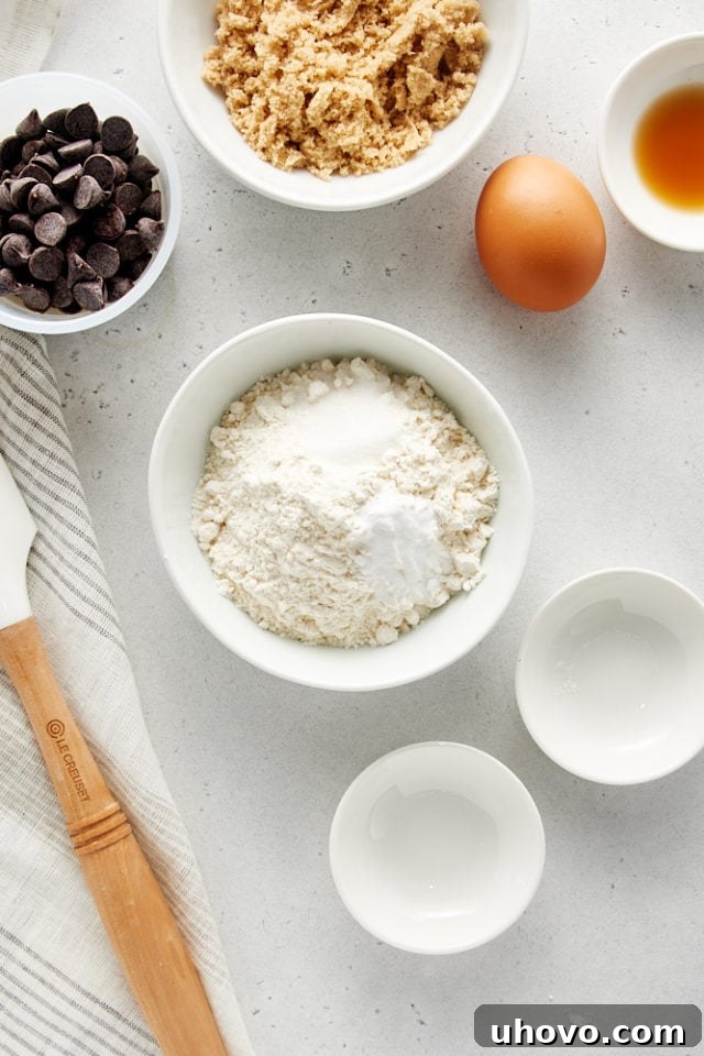 Overhead shot of all-purpose flour, baking soda, and salt measured into a white mixing bowl, awaiting the next step in the Deep Dish Chocolate Chip Cookie recipe.