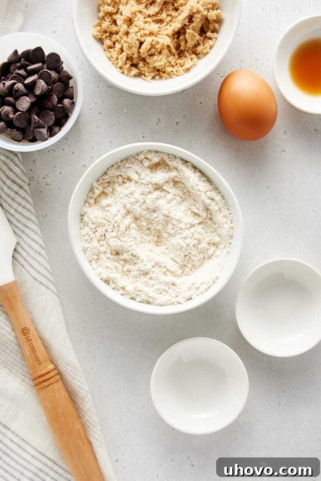Overhead view of dry ingredients for Deep Dish Chocolate Chip Cookies perfectly whisked together in a white bowl, ready to be combined with the wet ingredients.