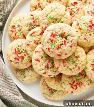 Overhead view of Soft Christmas Sprinkle Sugar Cookies on a large white plate