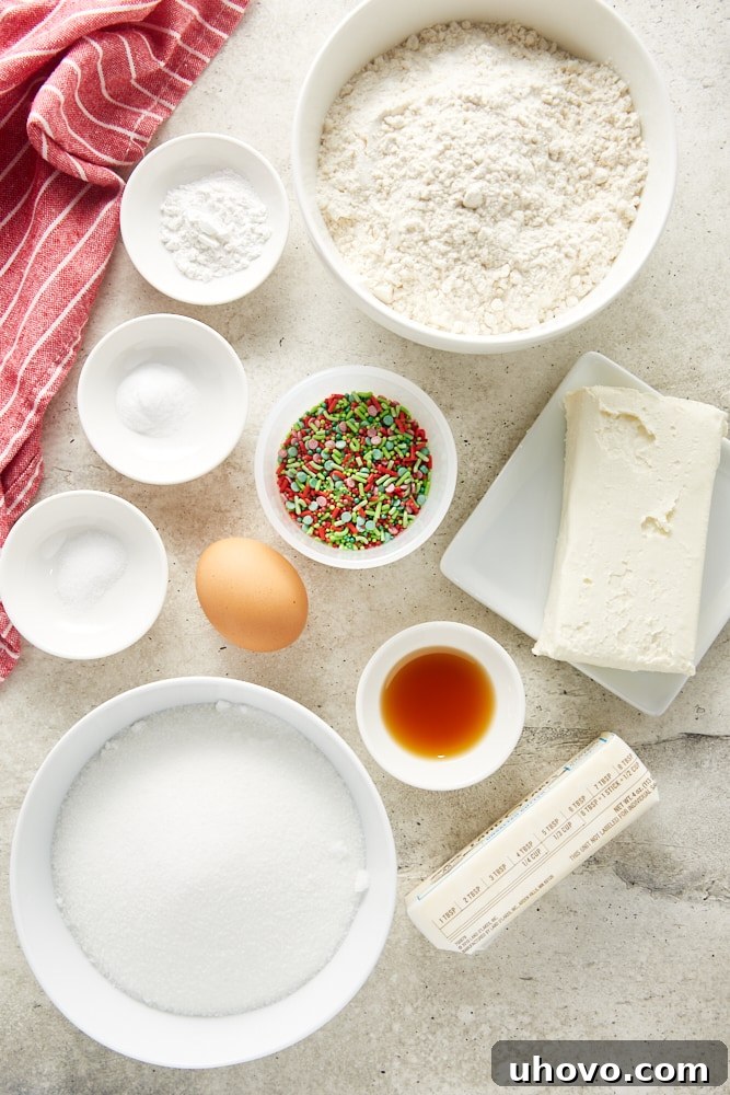 Overhead view of all ingredients for no-roll sugar cookies laid out on a white surface.