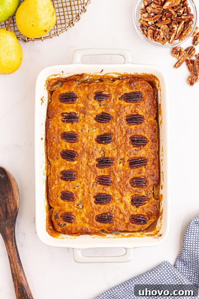 Overhead view of the freshly baked caramel apple pear cobbler, golden brown and bubbling, still in its rectangular baking pan.