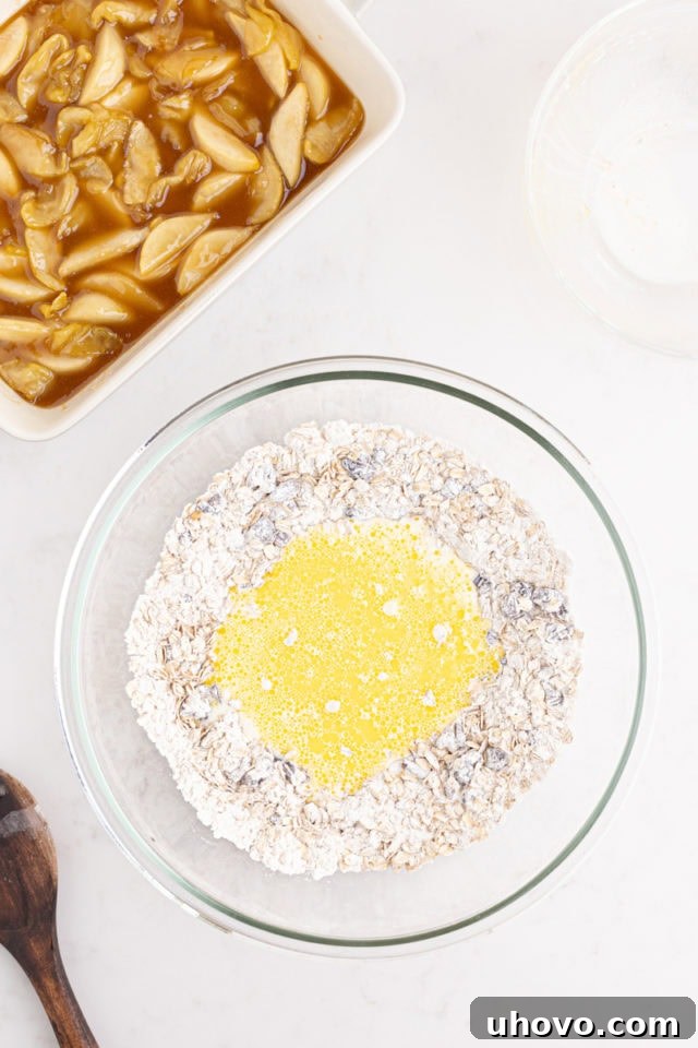 Overhead view of milk, melted butter, and beaten egg being poured into the dry crust ingredients in a bowl, ready for mixing.
