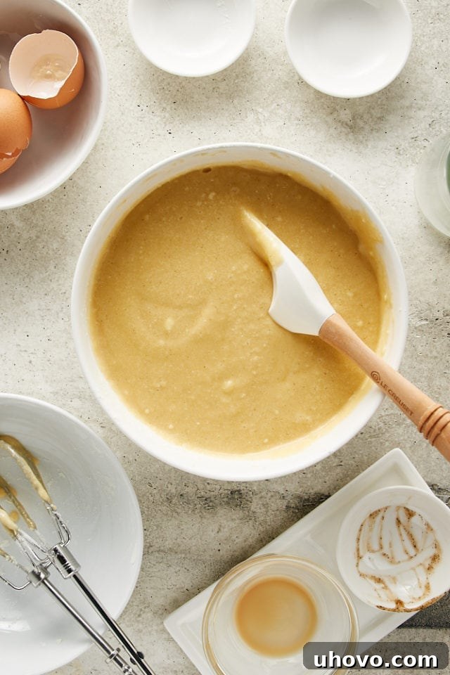 A smooth, well-mixed Irish Cream Cake batter resting in a white mixing bowl, ready for baking.
