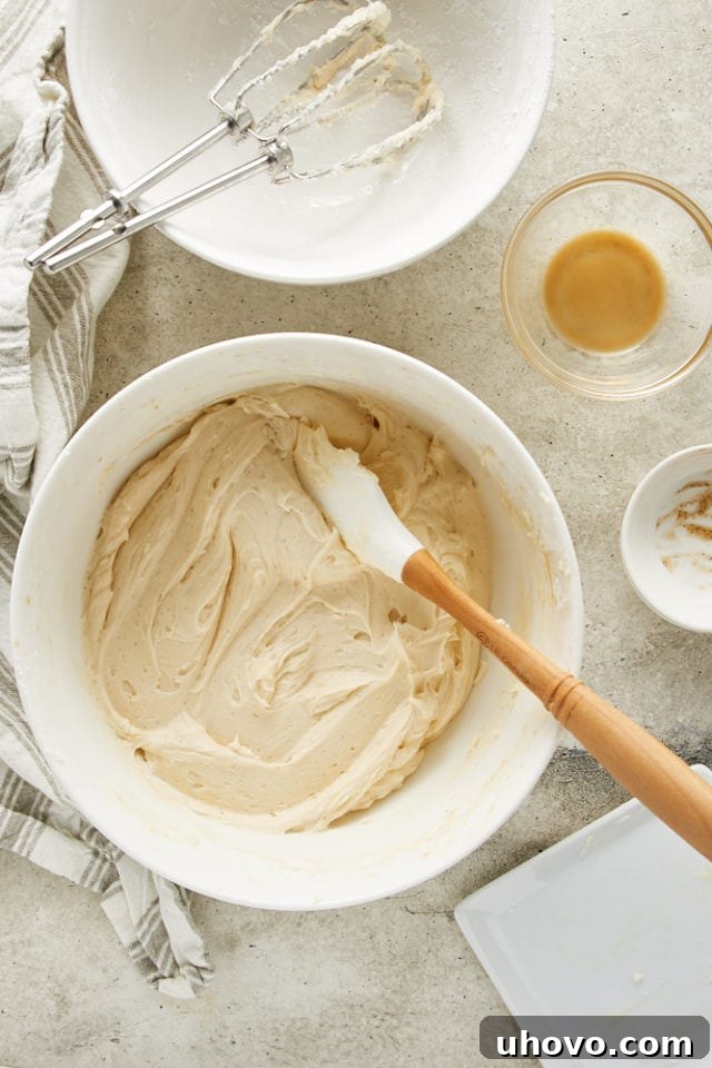A perfectly smooth and fluffy Irish Cream frosting, glistening in a white mixing bowl, ready to adorn the cake.