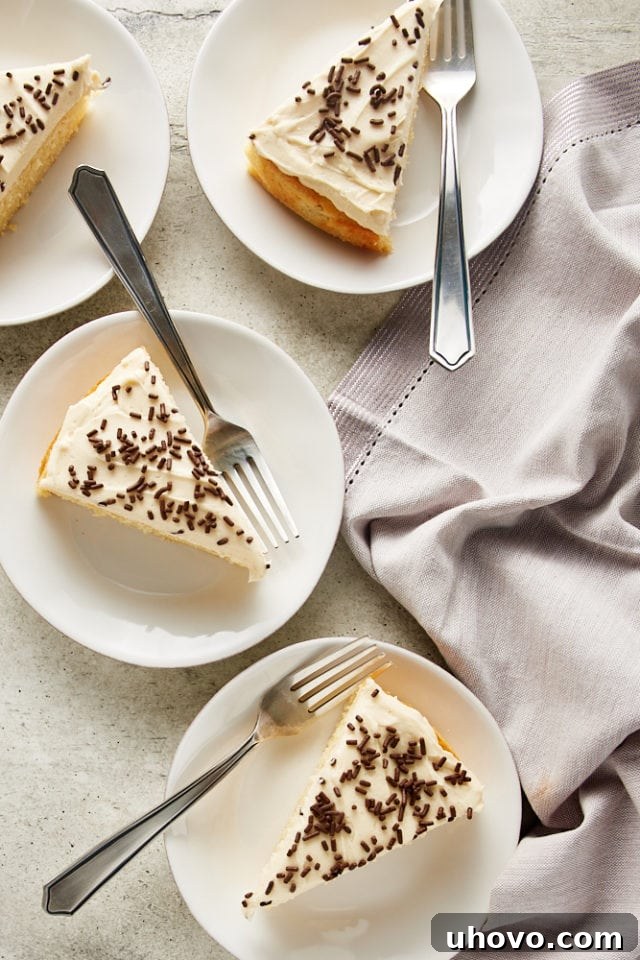 An overhead view of multiple slices of Irish Cream Cake neatly arranged on white plates, showcasing the moist cake and creamy frosting.
