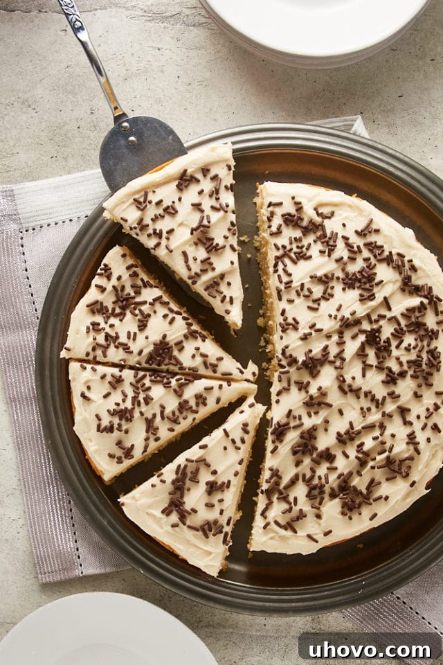 An overhead view of a perfectly sliced Irish Cream Cake on a pewter cake plate, revealing its tender layers and creamy frosting.