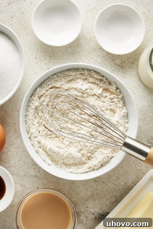 Close-up, overhead view of the perfectly combined and whisked dry ingredients for the Irish Cream Cake in a white bowl.