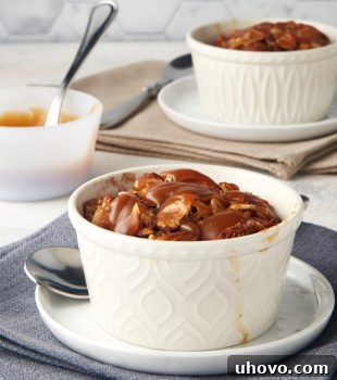 Cinnamon Almond Bread Pudding for Two in white ramekins on white plates