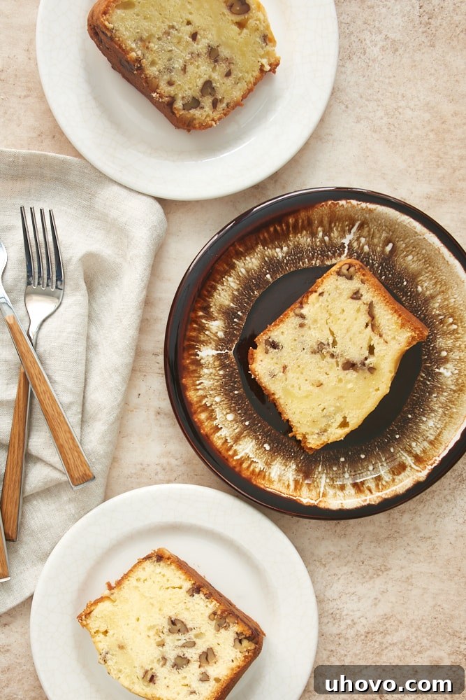 Overhead view of several slices of Cream Cheese Pound Cake on white and brown plates, highlighting its versatility.