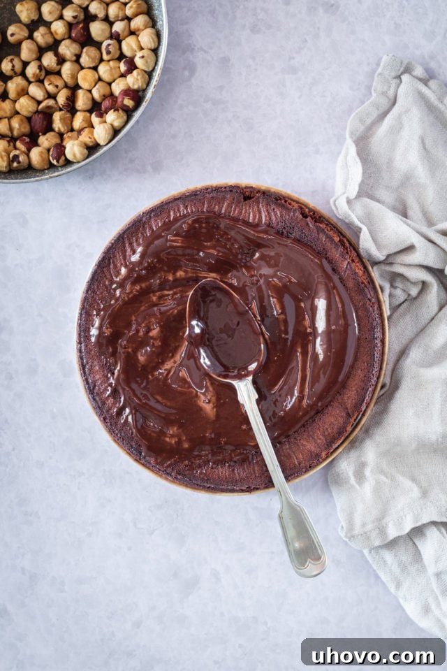 frosting a chocoalte cake with a spoon
