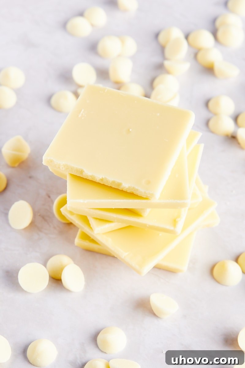 stack of white chocolate pieces surrounded by white chocolate chips