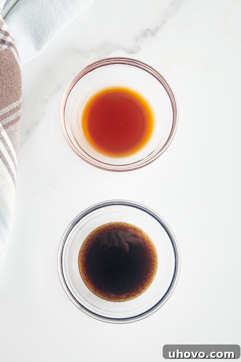 overhead view of vanilla extract and vanilla bean paste in glass bowls