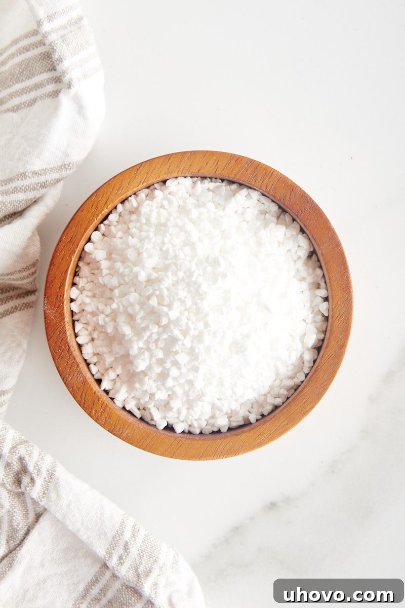 overhead view of pearl sugar in a small wooden bowl