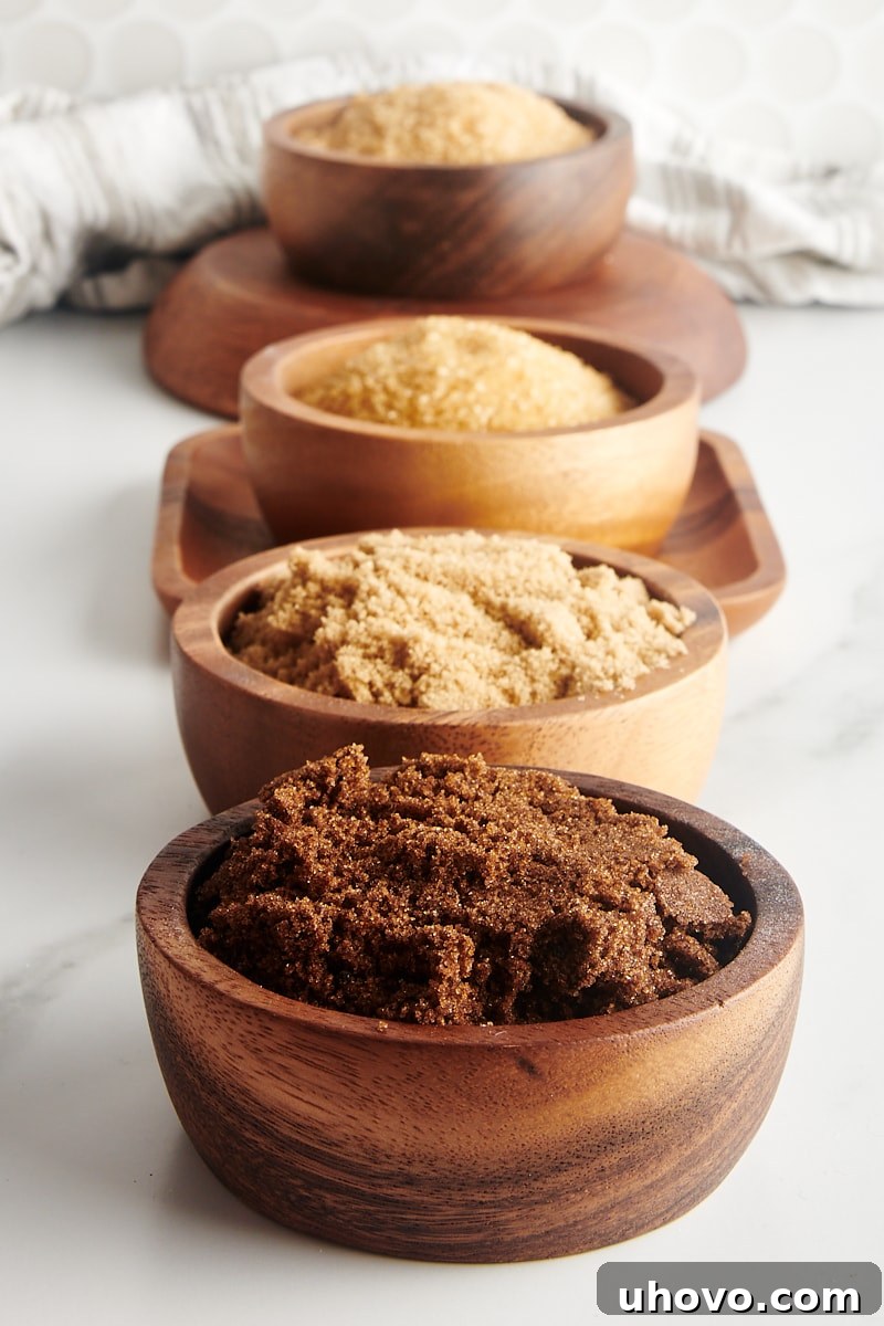 dark and light muscovado sugars, demerara sugar, and turbinado sugar in wooden bowls