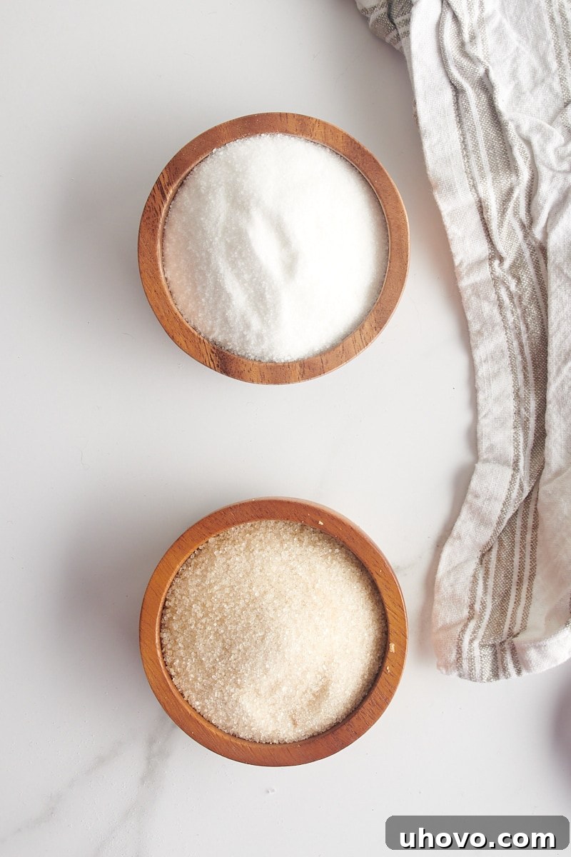 overhead view of granulated sugar and cane sugar in small wooden bowls