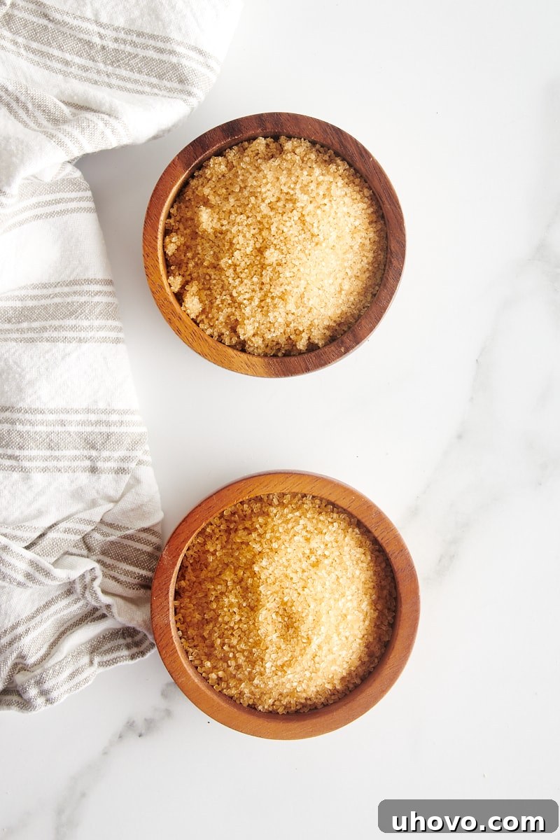 overhead view of turbinado sugar and demerara sugar in small wooden bowls