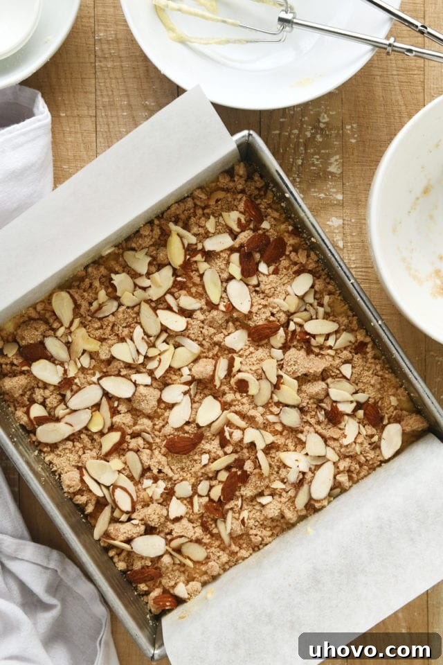 Overhead view of the Almond Crumb Cake in the square baking pan, fully assembled and ready to go into the oven.