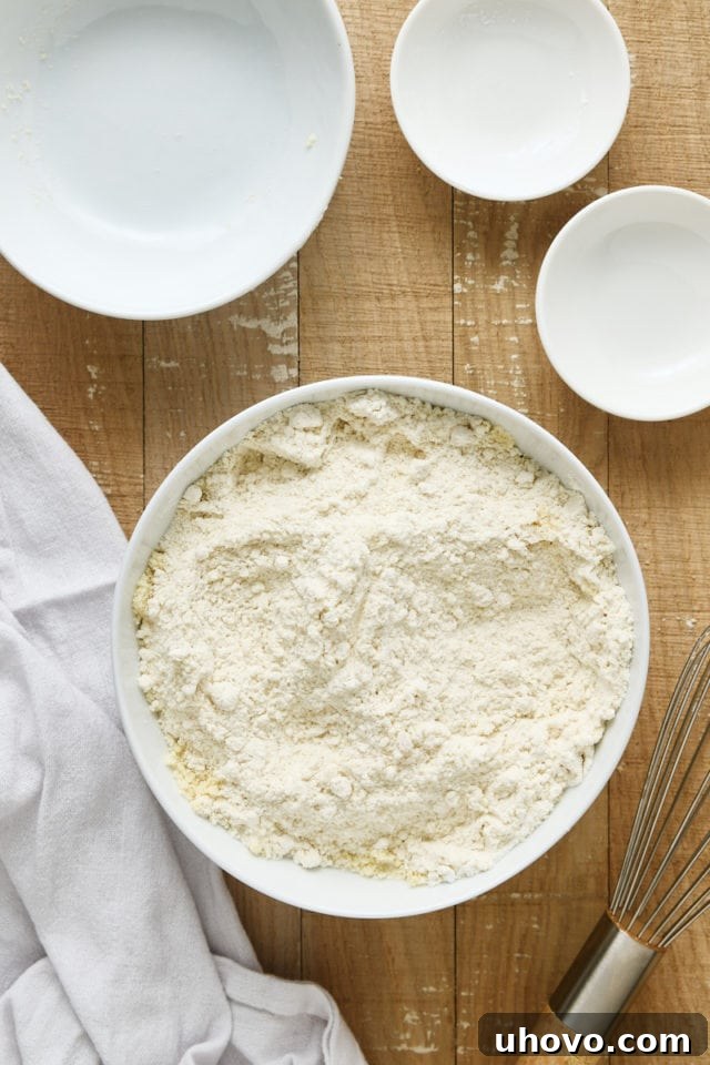 Overhead view of the thoroughly mixed dry ingredients for Almond Crumb Cake in a white mixing bowl.