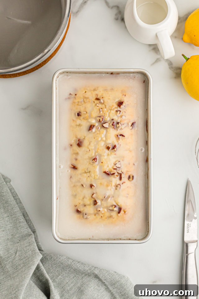 Overhead view of lemon bread in pan with glaze
