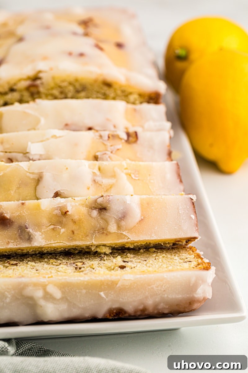 Sliced glazed lemon bread on serving tray