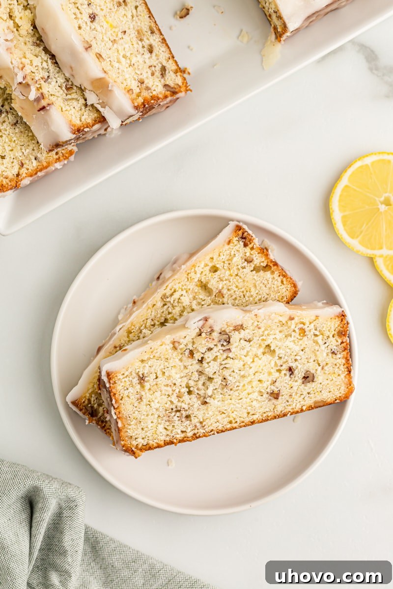 Overhead view of two slices of lemon bread on white plate