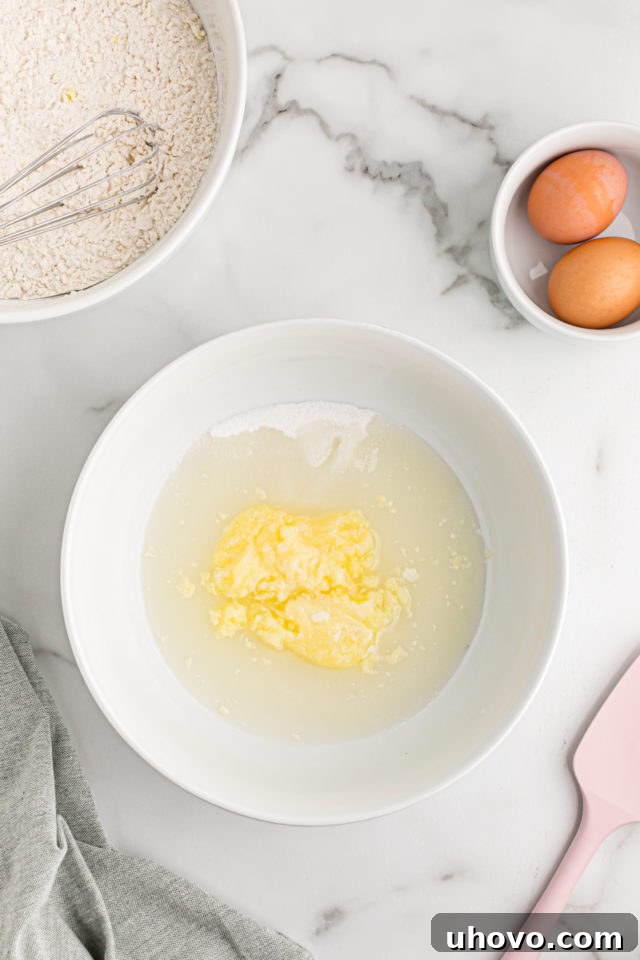Overhead view of wet ingredients in mixing bowl before mixing